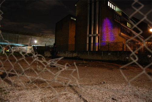 An abstract pattern projected onto a brick wall.